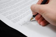 Person Signing in Documentation Paper